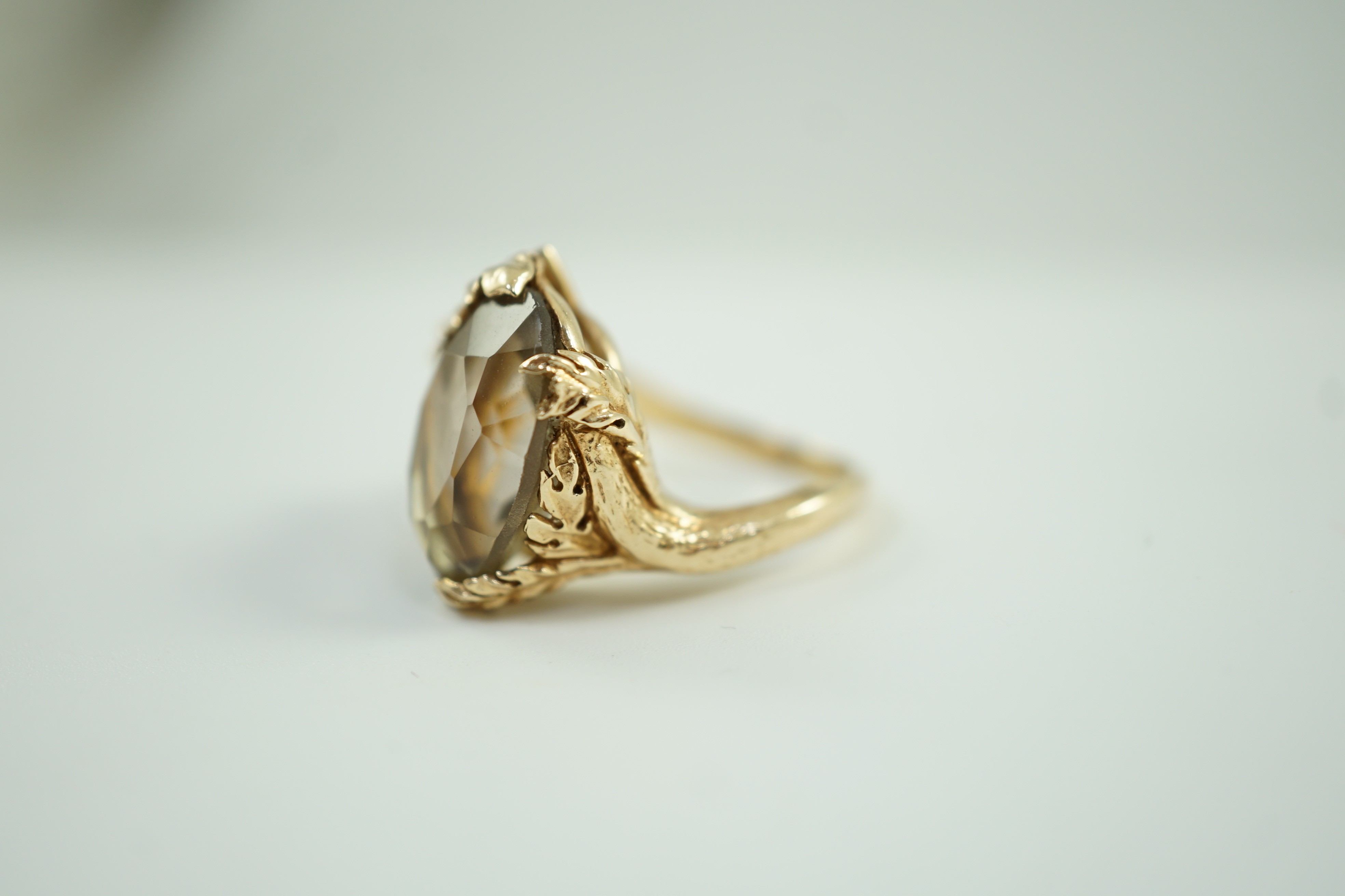 A 10k yellow metal, smoky quartz and white stone set dress ring, size M, gross weight 7.3 grams.